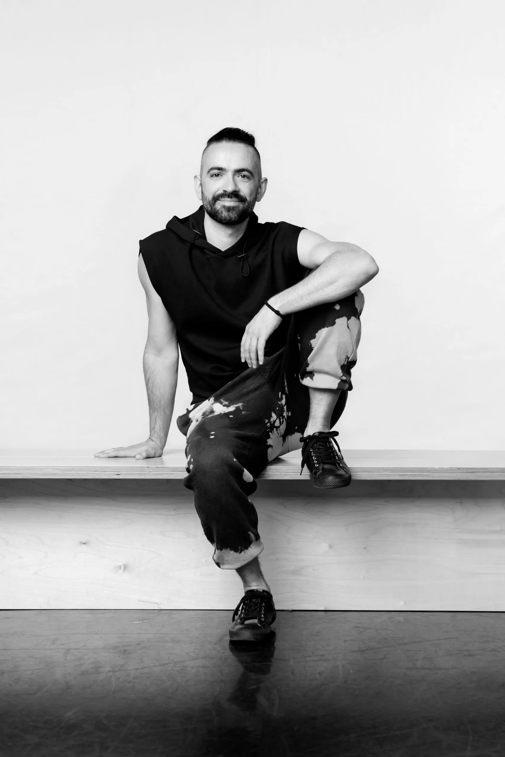 Symeon Kyriakopoulos seated in a Pilates studio